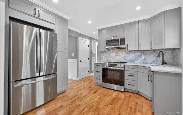a kitchen with stainless steel appliances a refrigerator sink and cabinets
