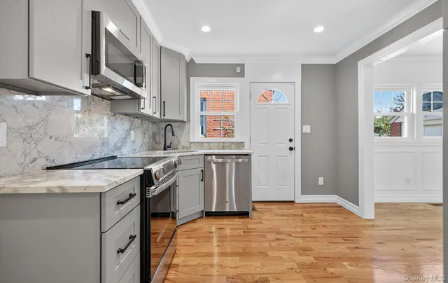 a kitchen with stainless steel appliances granite countertop a stove and a sink