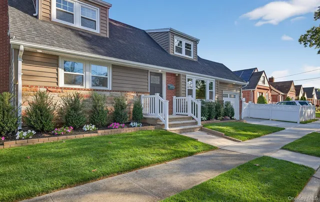 a front view of a house with a yard table and seating
