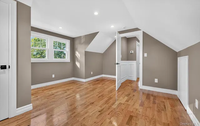 a view of a livingroom with wooden floor and a window