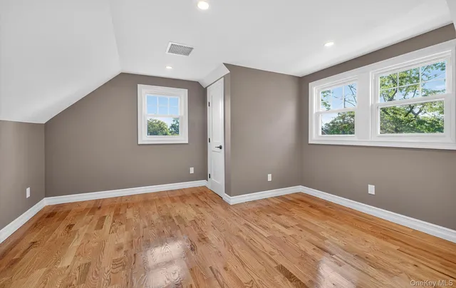 a view of room with window and wooden floor