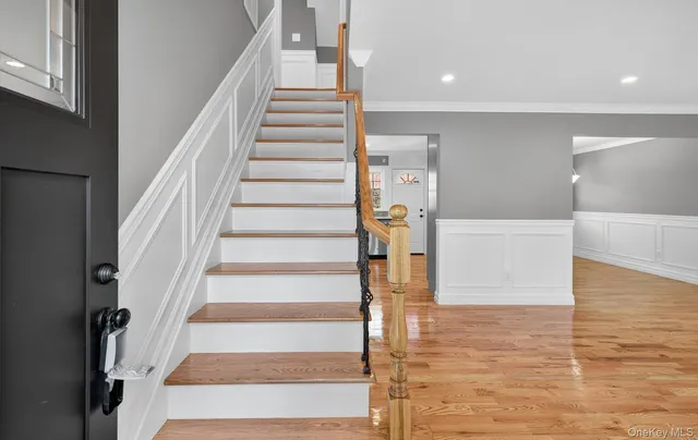a view of entryway and hall with wooden floor