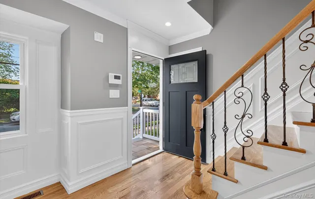 a view of an entryway with wooden floor