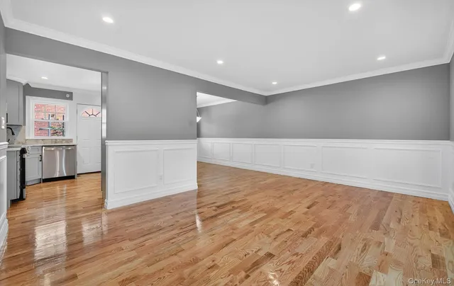 a view of kitchen with refrigerator and wooden floor