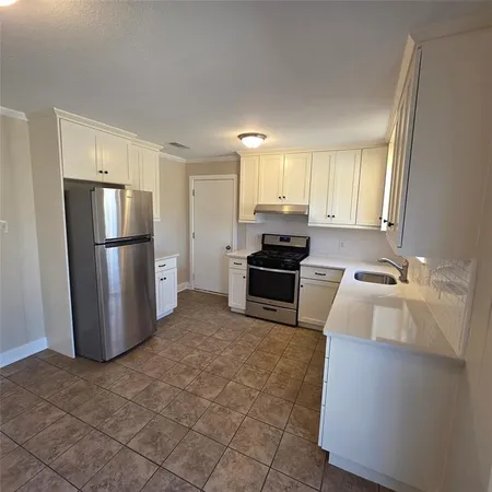 a kitchen with a refrigerator sink and stove