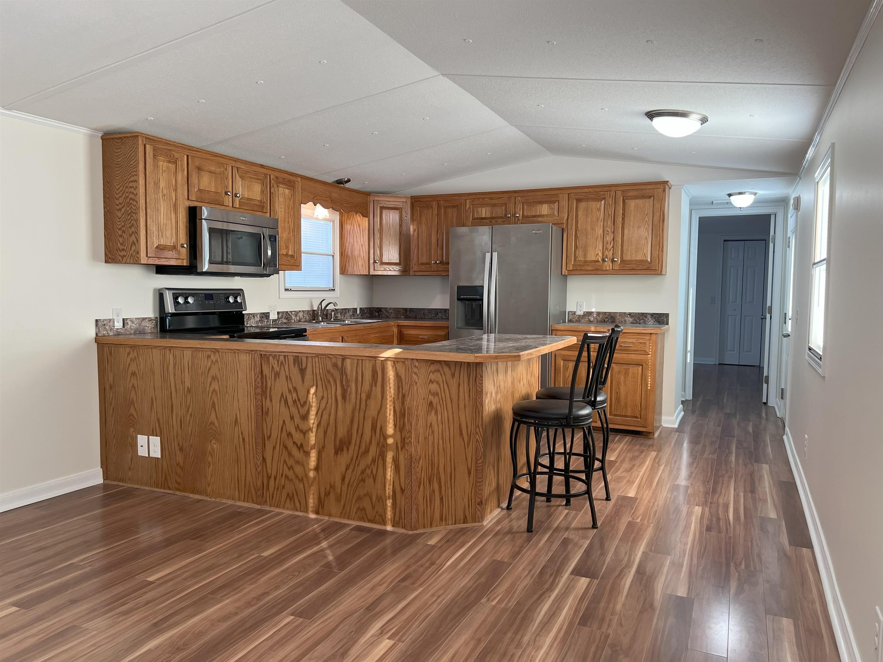 39 Harriston Road Grottoes, VA 24441 - Photo 3 of 38 a kitchen with stainless steel appliances a microwave a stove a sink dishwasher a microwave oven with cabinets and wooden floor