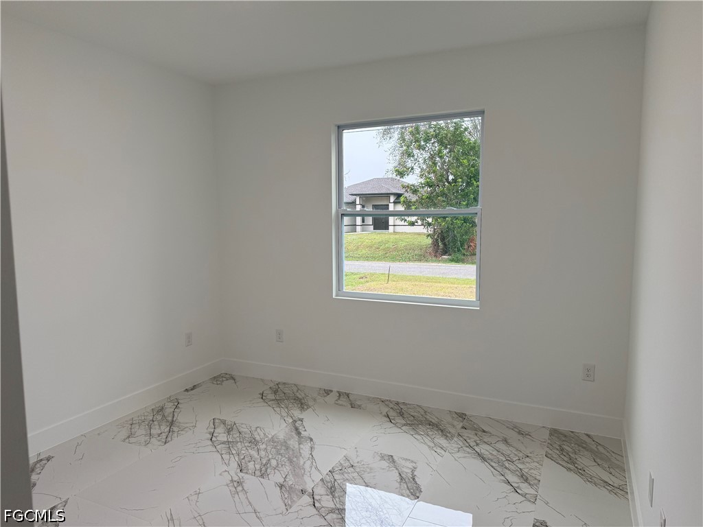 3203 24th Street Southwest Lehigh Acres, FL 33976 - Photo 19 of 19 a view of a room that has a window
