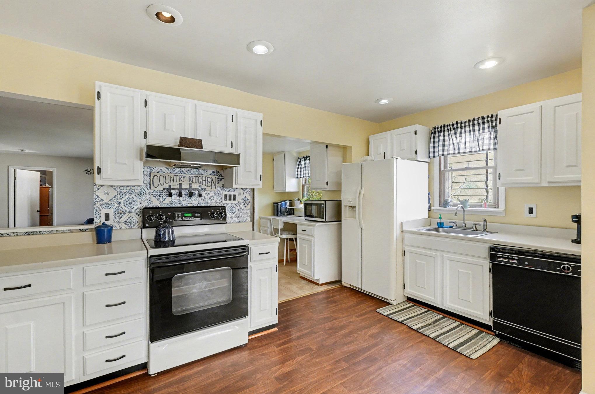 7316 Hughes Avenue Baltimore, MD 21219 - Photo 13 of 43 a kitchen with stainless steel appliances a stove sink and refrigerator