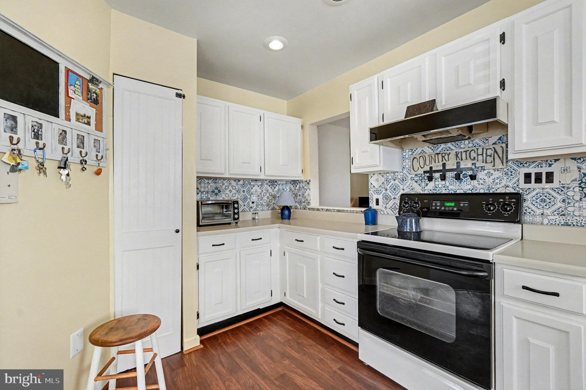 7316 Hughes Avenue Baltimore, MD 21219 - Photo 14 of 43 a kitchen with stainless steel appliances a stove a sink and a refrigerator