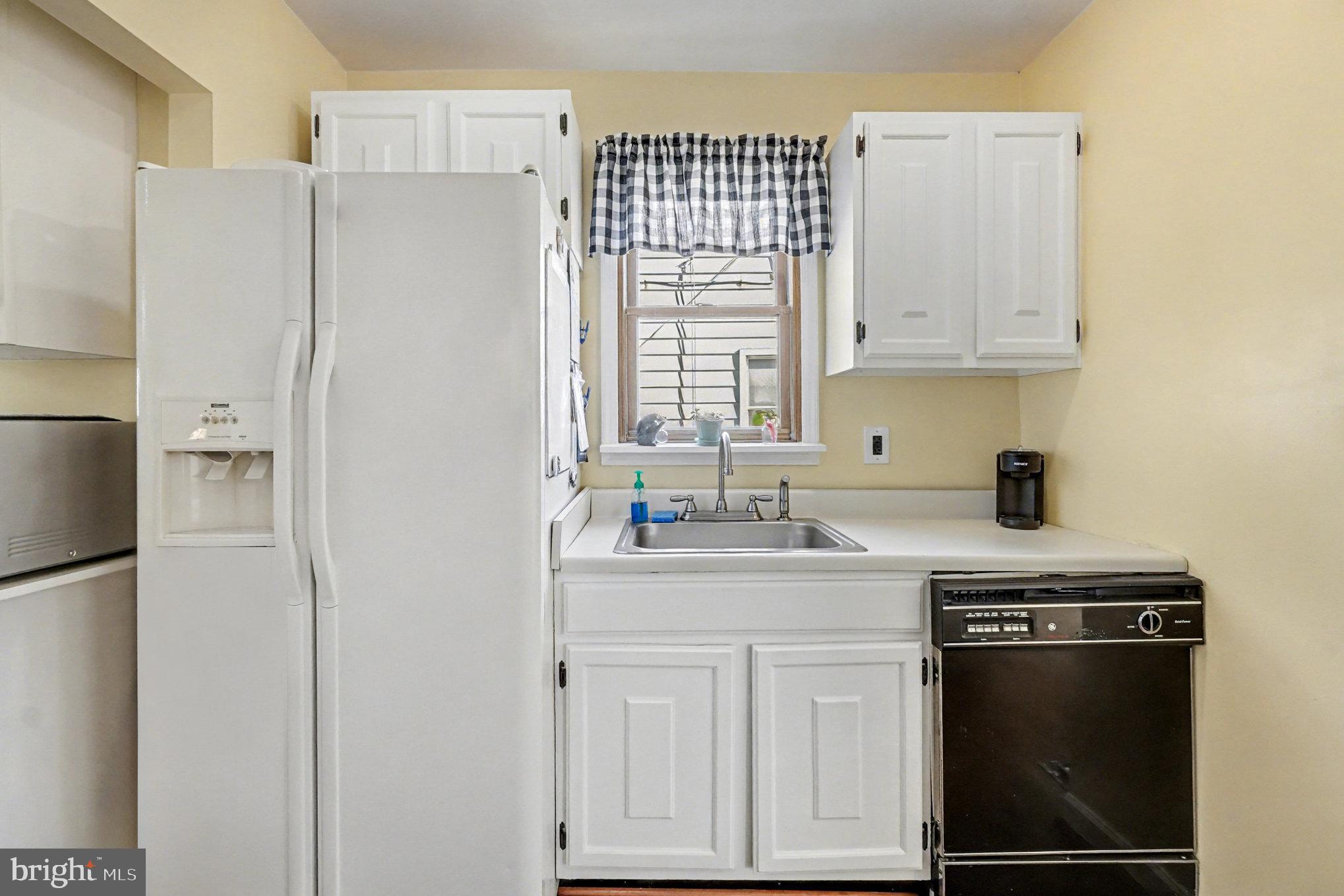 7316 Hughes Avenue Baltimore, MD 21219 - Photo 15 of 43 a kitchen with stainless steel appliances white cabinets and a refrigerator