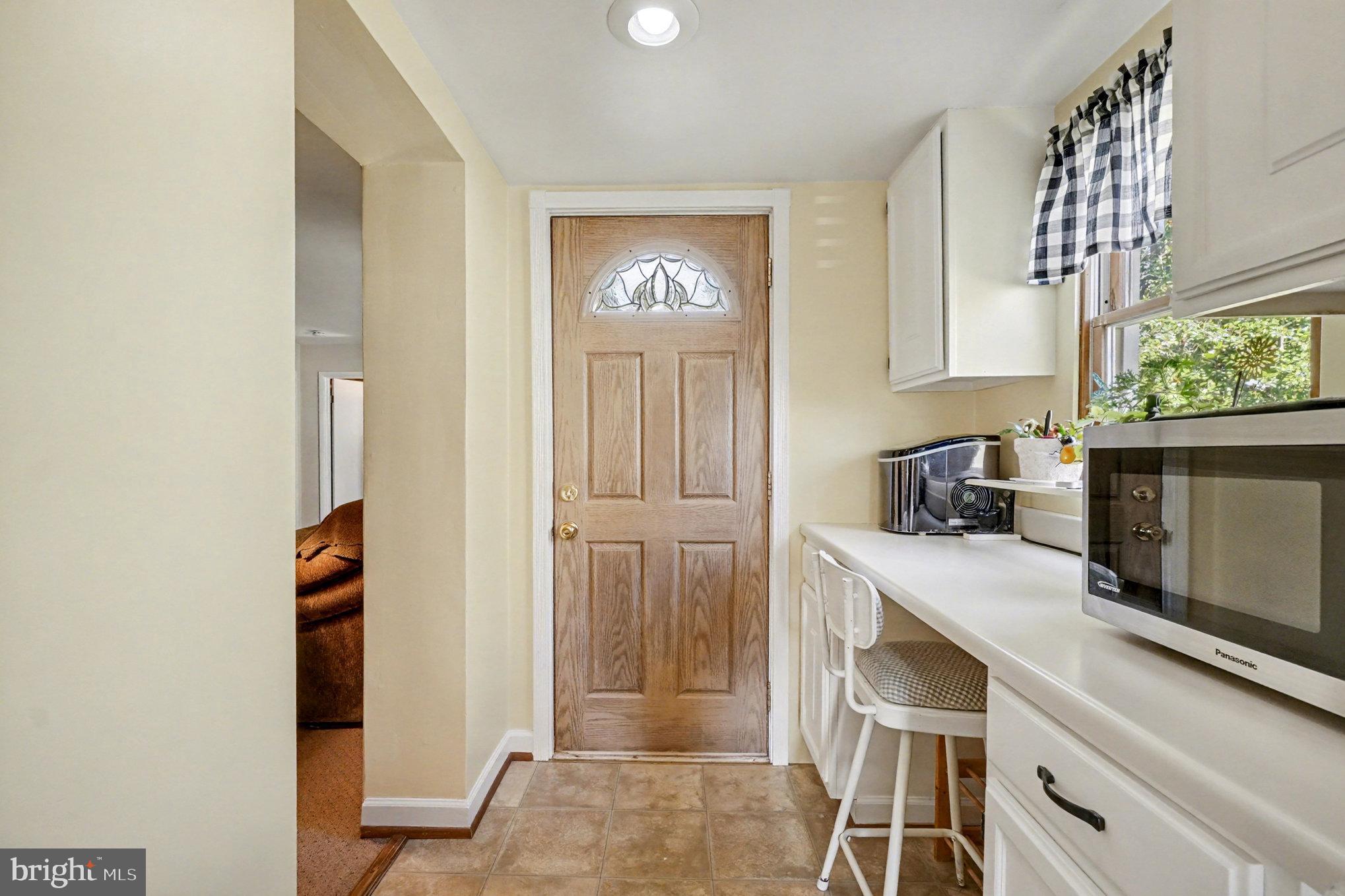 7316 Hughes Avenue Baltimore, MD 21219 - Photo 17 of 43 a view of a kitchen with fridge and wooden floor