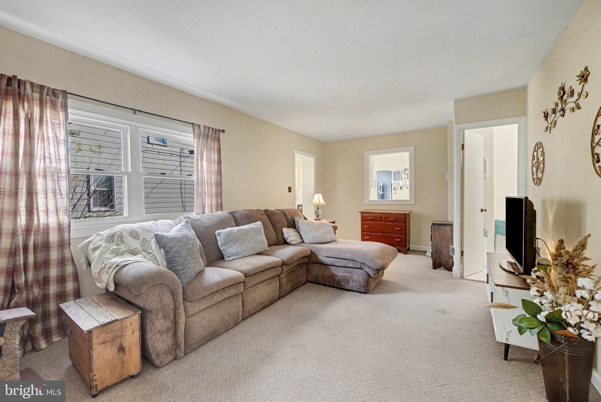 7316 Hughes Avenue Baltimore, MD 21219 - Photo 19 of 43 a living room with furniture and a flat screen tv