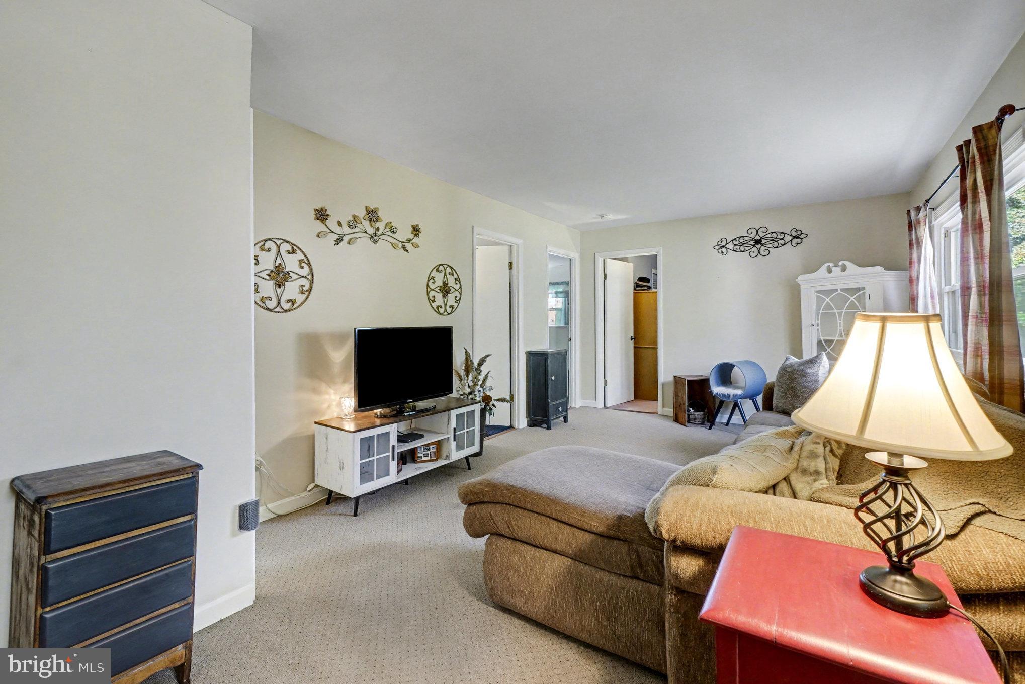7316 Hughes Avenue Baltimore, MD 21219 - Photo 21 of 43 a living room with furniture a flat screen tv and a window
