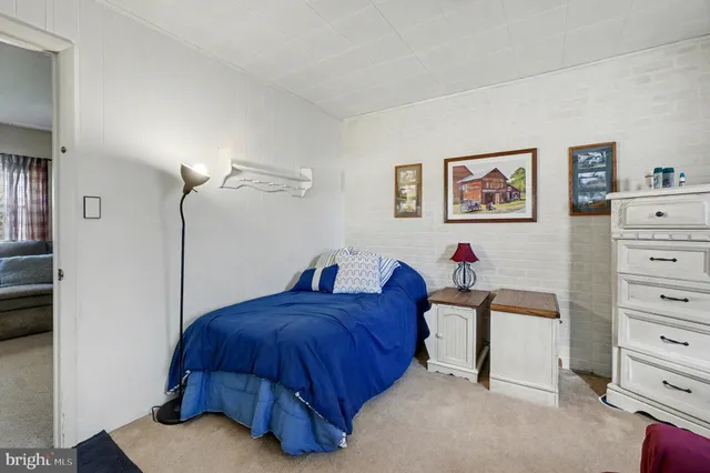 a bedroom with a bed and a television