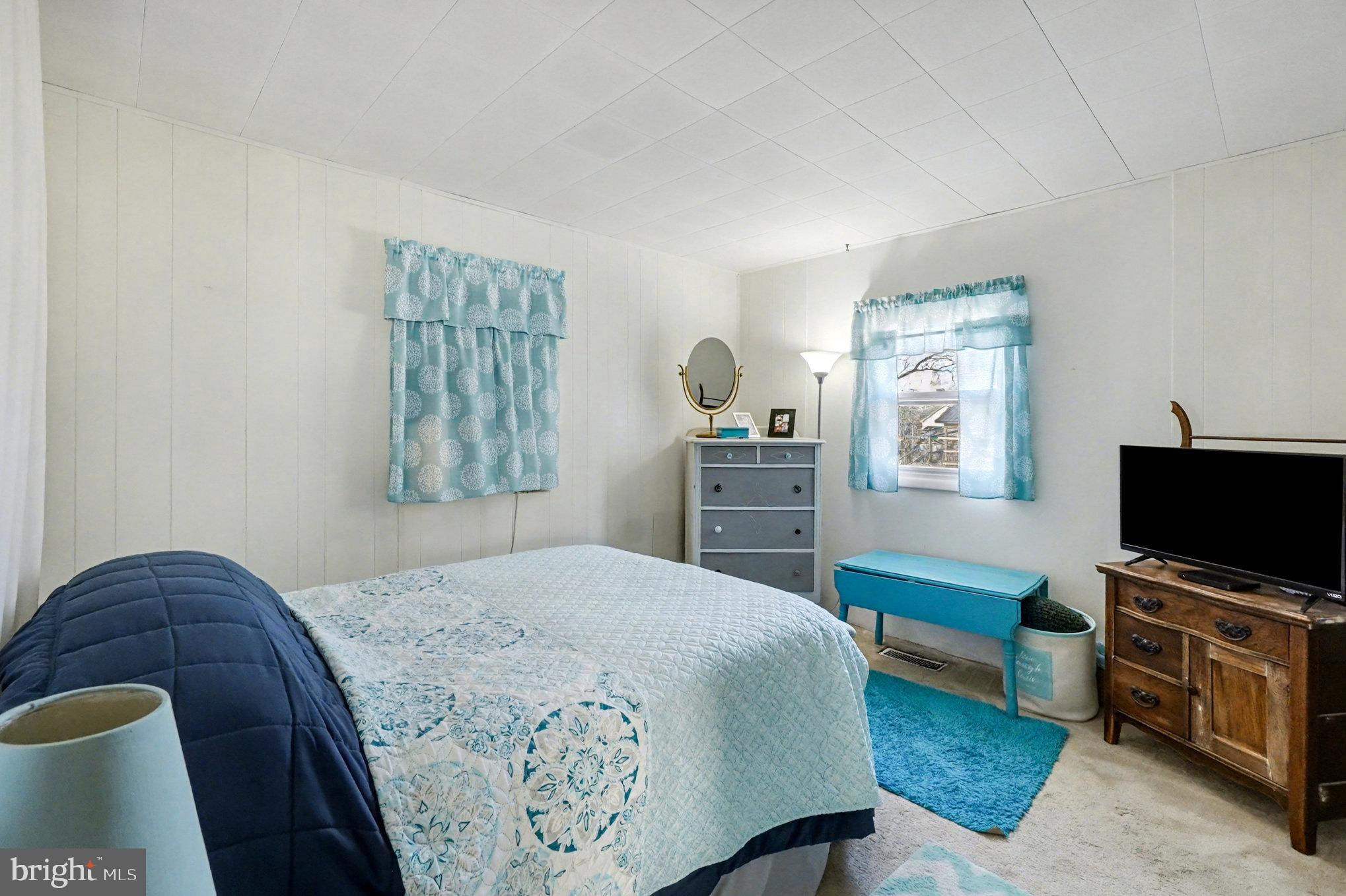 7316 Hughes Avenue Baltimore, MD 21219 - Photo 25 of 43 a bedroom with a bed and a television