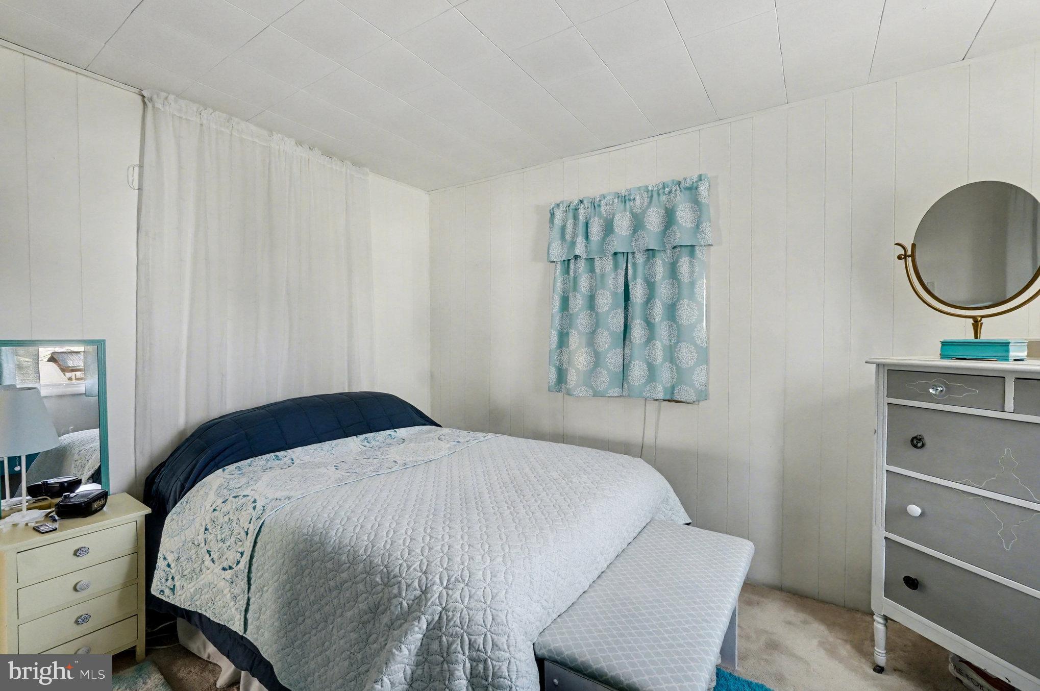 7316 Hughes Avenue Baltimore, MD 21219 - Photo 26 of 43 a bedroom with a bed and a dresser in it