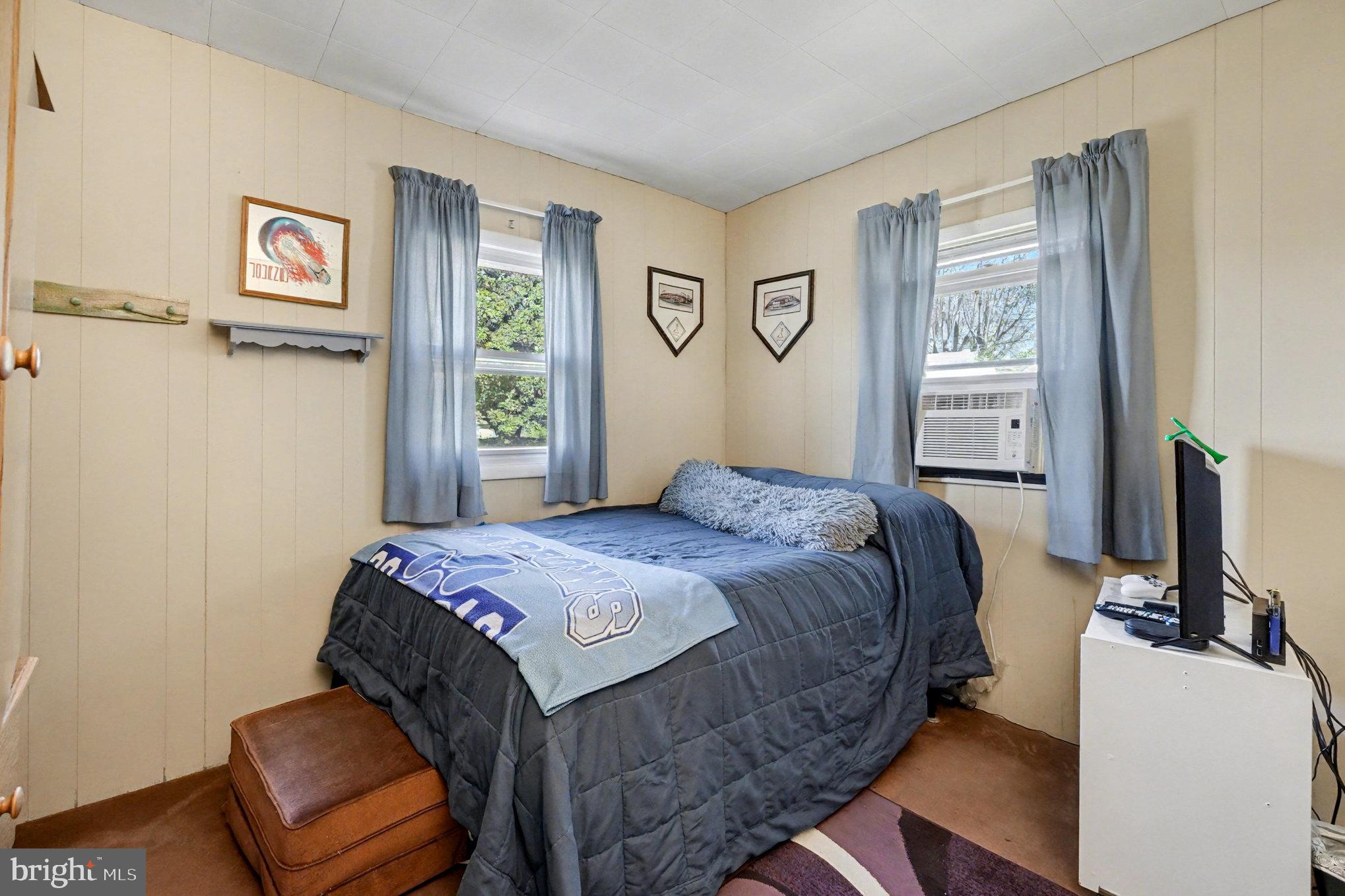 7316 Hughes Avenue Baltimore, MD 21219 - Photo 28 of 43 a bedroom with a bed and a flat screen tv