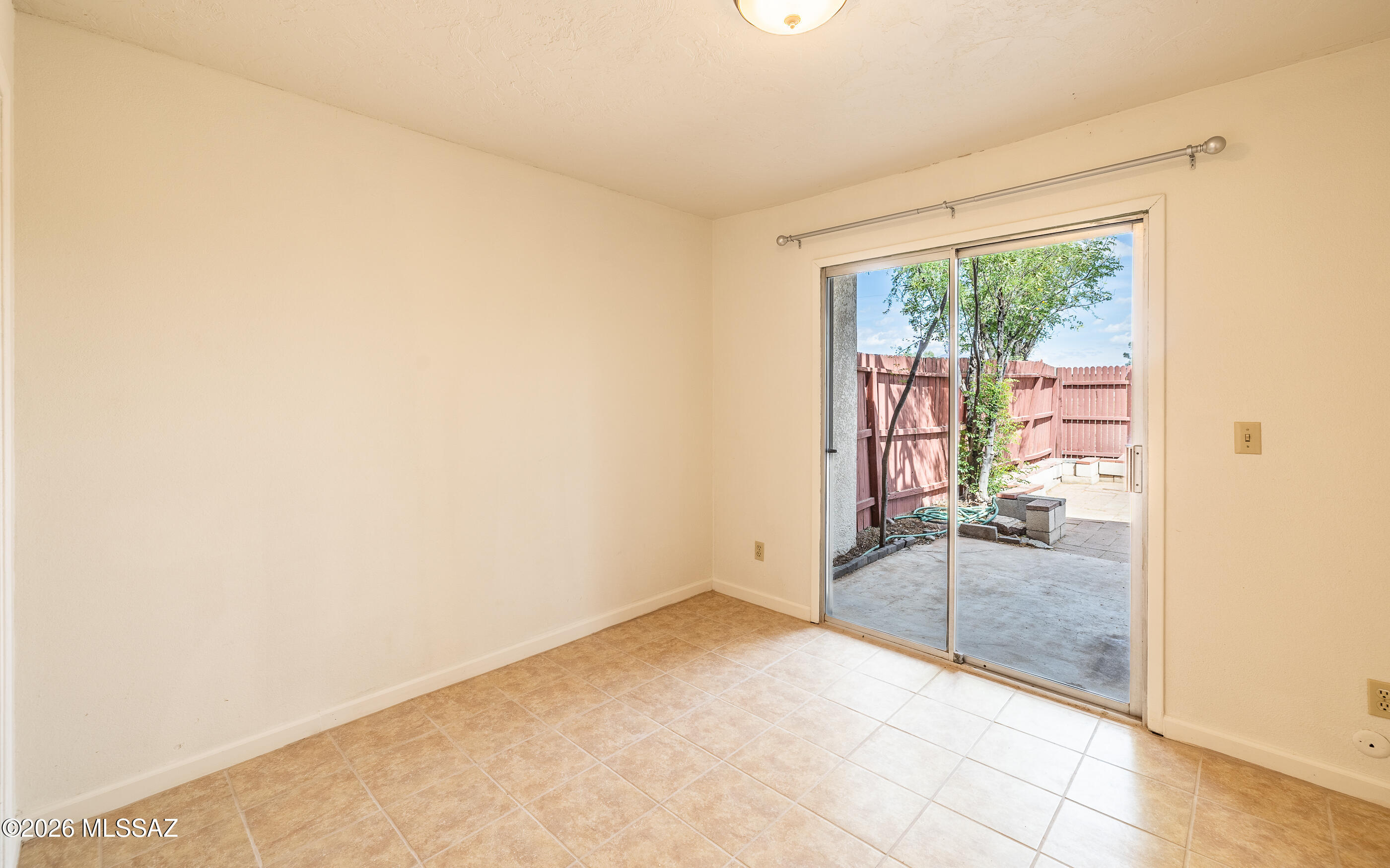 3750 North Country Club Road, Unit 46 Tucson, AZ 85716 - Photo 12 of 34 an empty room with sliding glass door