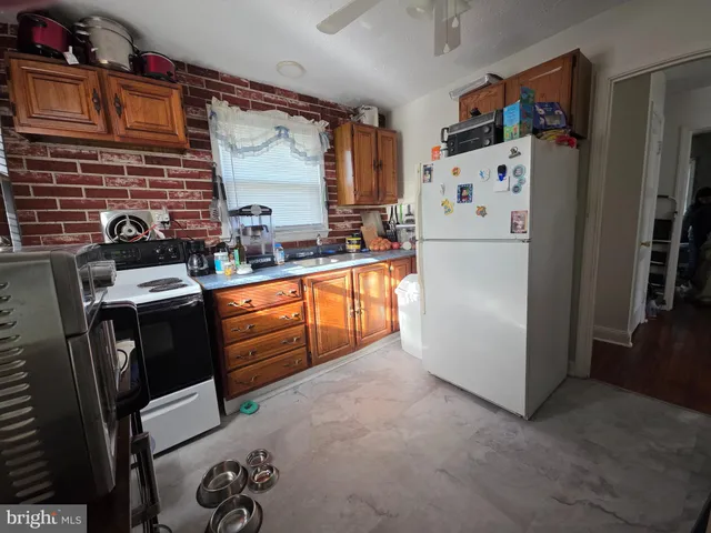 a kitchen with stainless steel appliances a refrigerator a stove a sink and cabinets