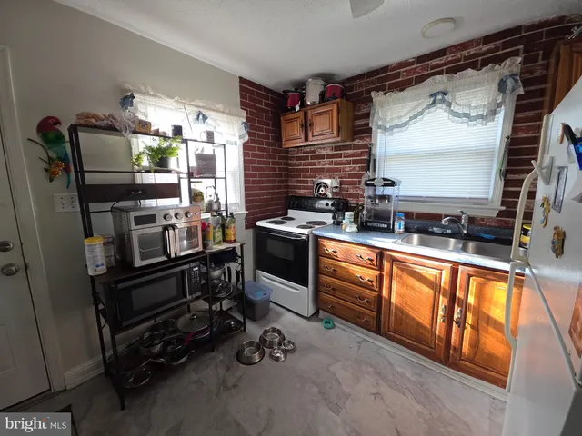a kitchen with stainless steel appliances a stove sink and refrigerator