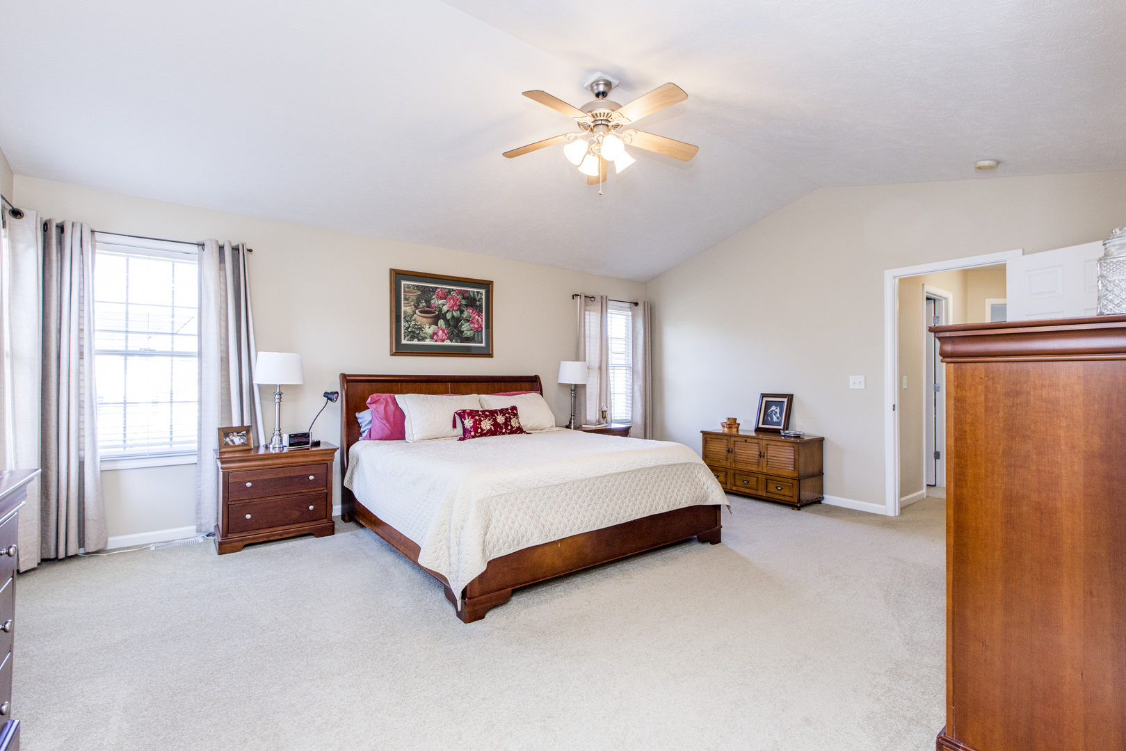 1511 Biltmore Court Normal, IL 61761 - Photo 16 of 35 a spacious bedroom with a bed and a chandelier