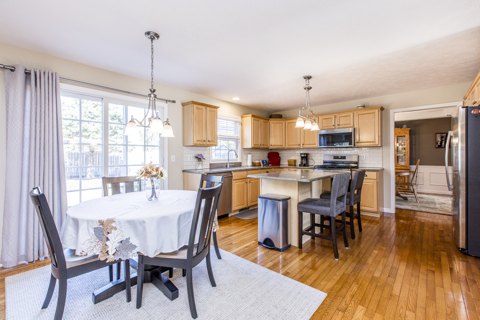 1511 Biltmore Court Normal, IL 61761 - Photo 3 of 35 a view of a dining room and livingroom with furniture wooden floor a chandelier