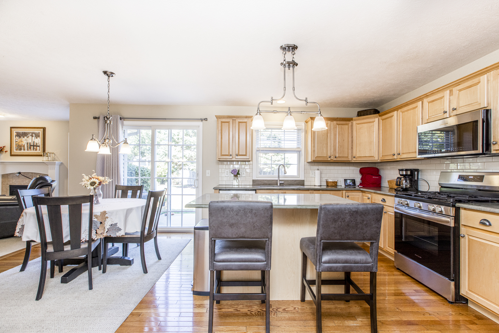 1511 Biltmore Court Normal, IL 61761 - Photo 4 of 35 a kitchen with stainless steel appliances a dining table chairs stove and white cabinets