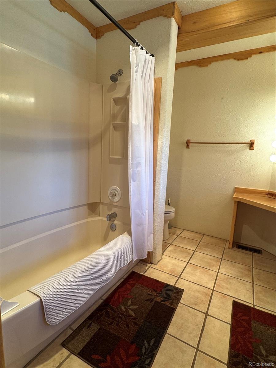 50002 County Rd LL56 Villa Grove, CO 81155 - Photo 18 of 40 a bathroom with a bathtub and a shower