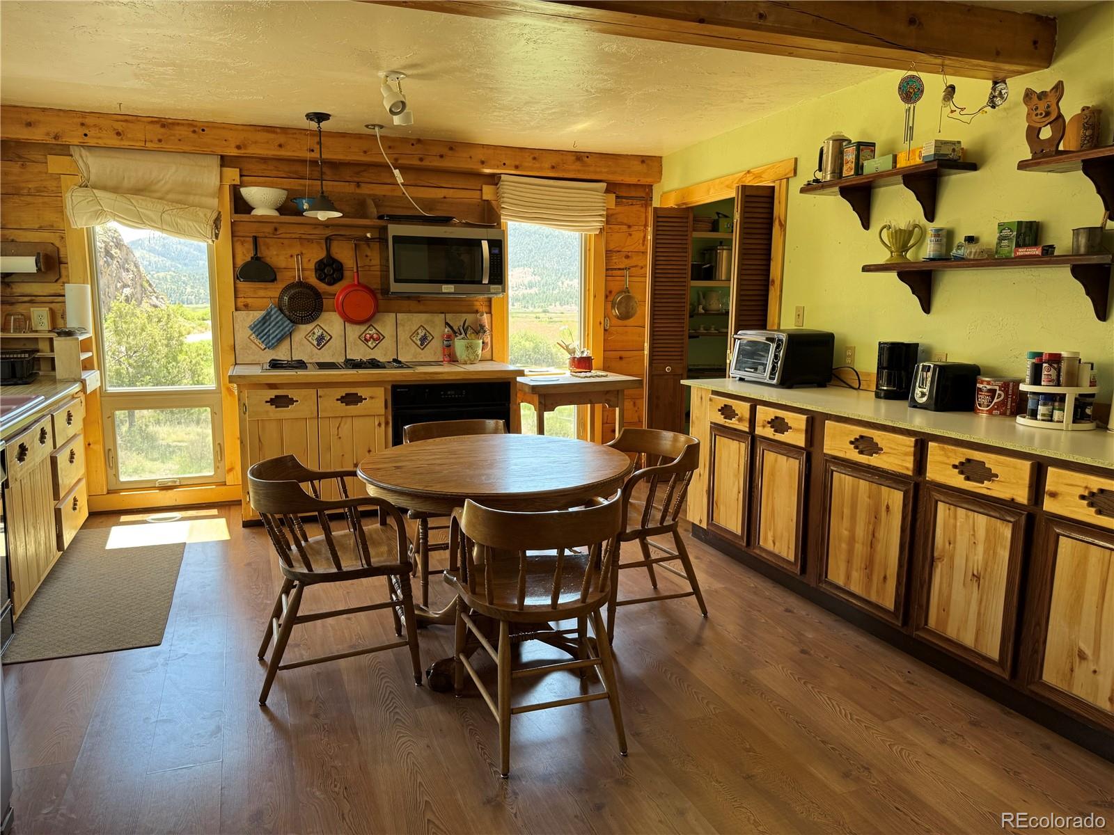 50002 County Rd LL56 Villa Grove, CO 81155 - Photo 22 of 40 a view of a dining room with furniture and wooden floor
