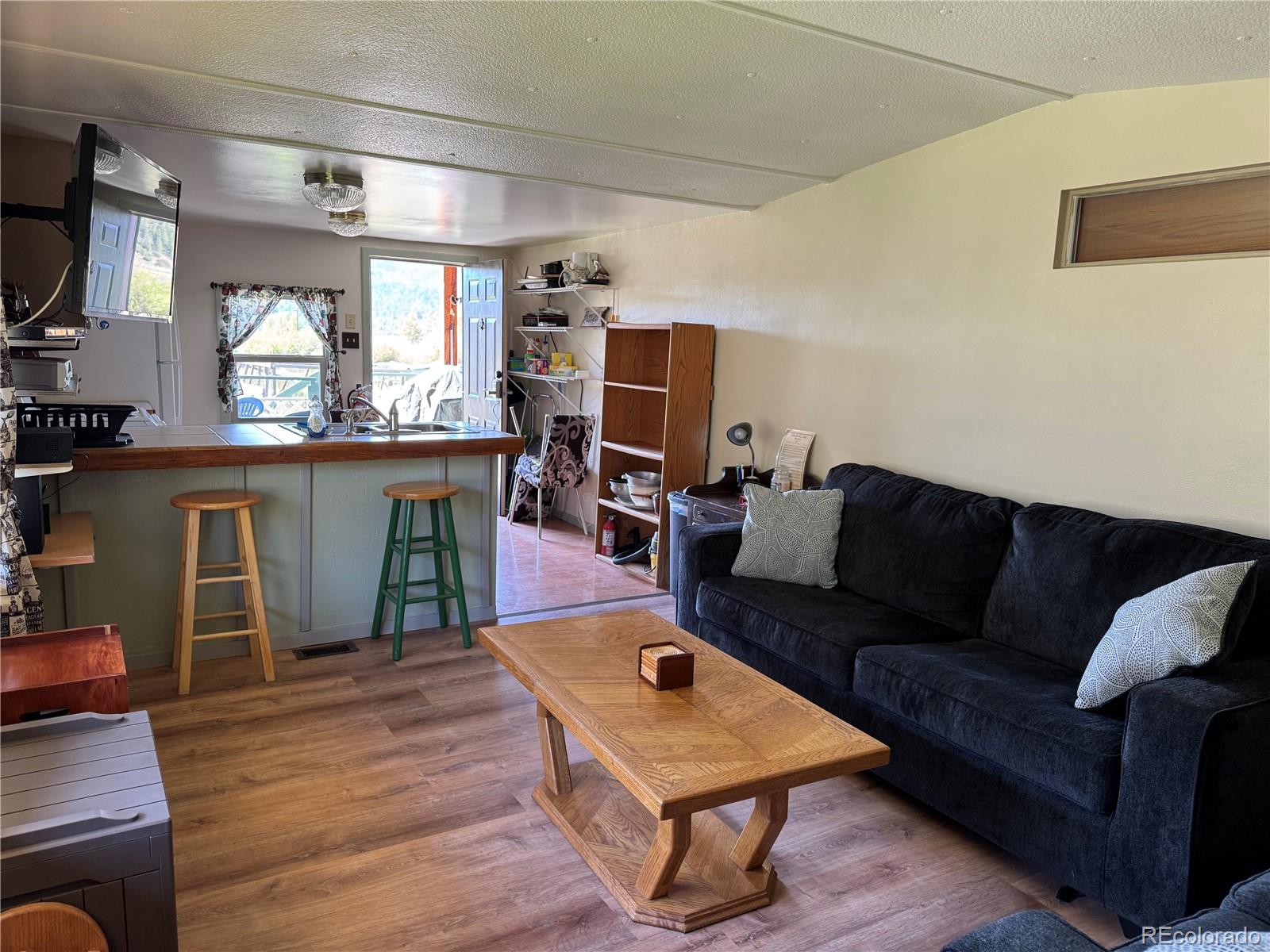 50002 County Rd LL56 Villa Grove, CO 81155 - Photo 32 of 40 a living room with furniture and a wooden floor