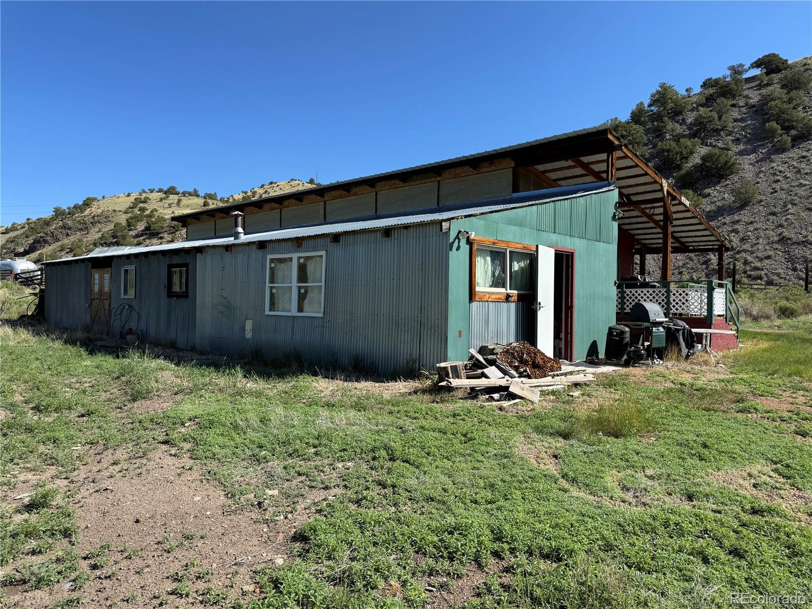 50002 County Rd LL56 Villa Grove, CO 81155 - Photo 35 of 40 a backyard of a house with table and chairs