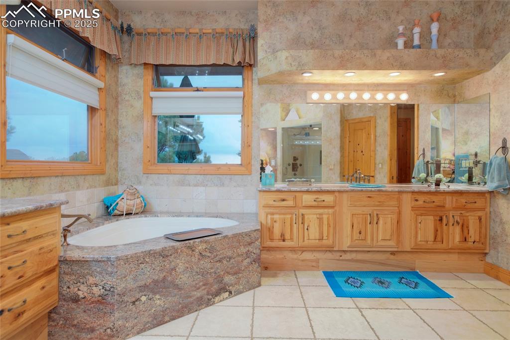 11771 East Smith Road Elbert, CO 80106 - Photo 28 of 35 a bathroom with a tub a sink and a window