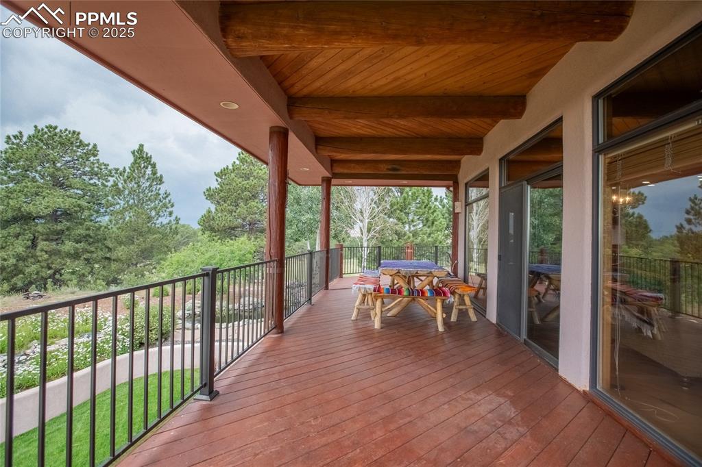 11771 East Smith Road Elbert, CO 80106 - Photo 31 of 35 a view of a patio with table and chairs potted plants with wooden floor