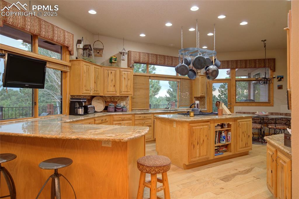 11771 East Smith Road Elbert, CO 80106 - Photo 7 of 35 a kitchen with stainless steel appliances granite countertop a sink a stove and a refrigerator