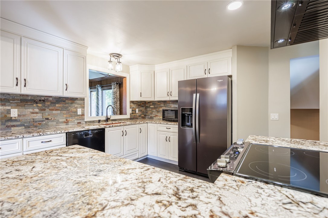 6 Jeanmoor Road Greece, NY 14616 - Photo 14 of 31 Kitchen features white wood cabinetry, granite cou