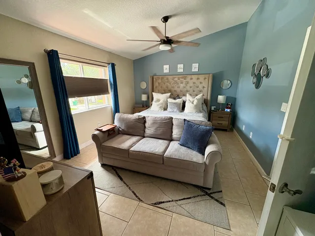 a living room with furniture and a large mirror