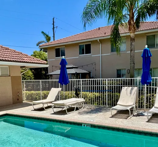 a view of a chair and table in backyard