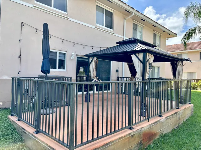a view of a house with iron fence