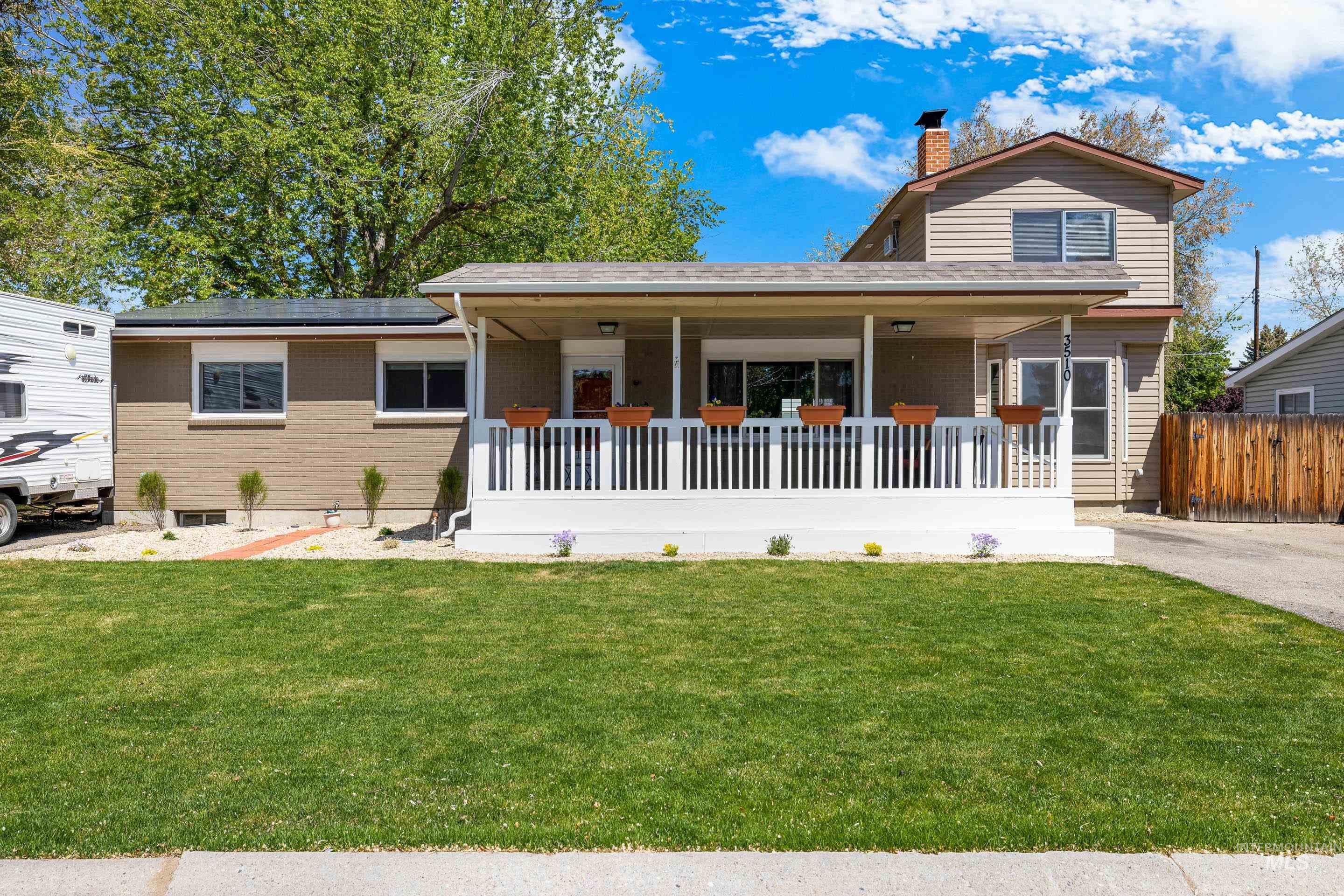 3510 Lassen Street Boise, ID 83703 - Photo 2 of 50 View of front of property with covered porch, a front yard, a chimney, and brick siding