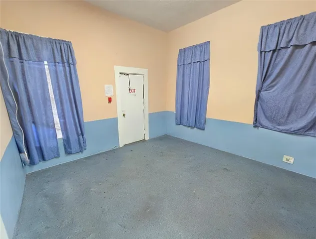 a view of a closet area with wooden floor