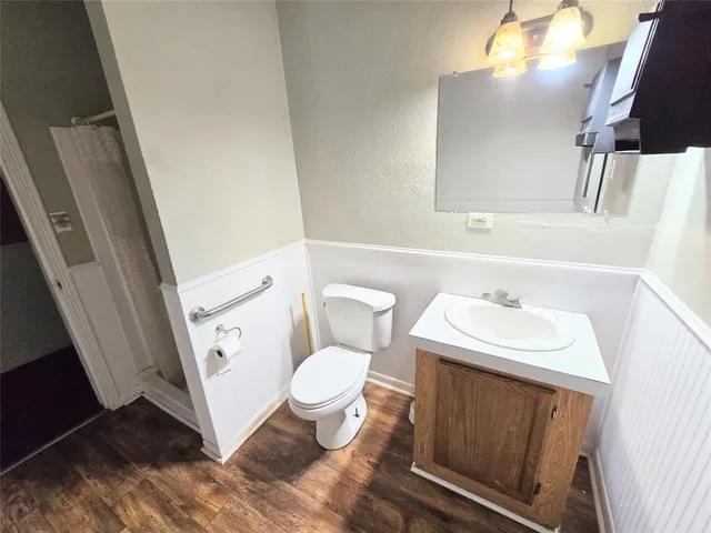 a bathroom with a sink toilet and mirror
