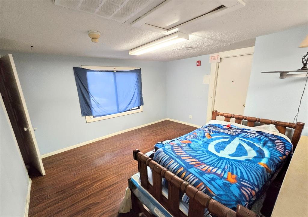 322 Capps Street Marlin, TX 76661 - Photo 26 of 34 a bedroom with a bed and wooden floor