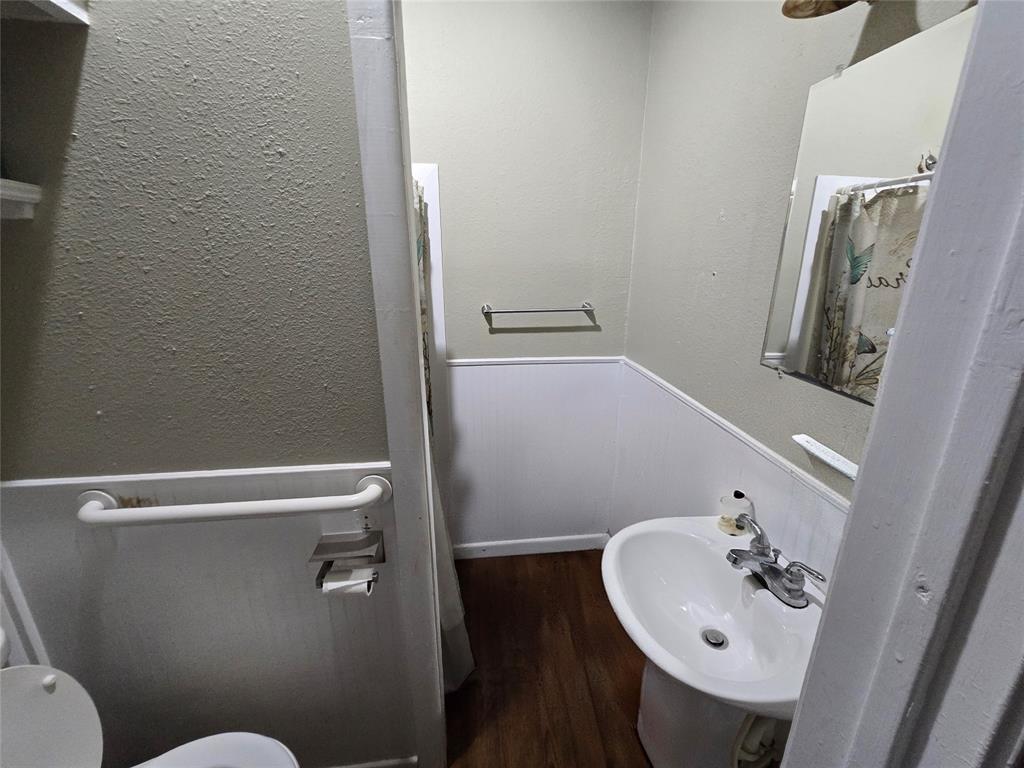 322 Capps Street Marlin, TX 76661 - Photo 9 of 34 a bathroom with a sink a toilet and shower