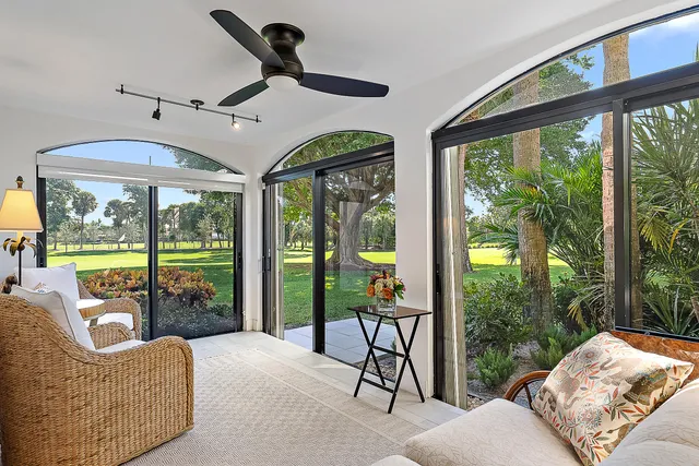 a living room with furniture and a floor to ceiling window