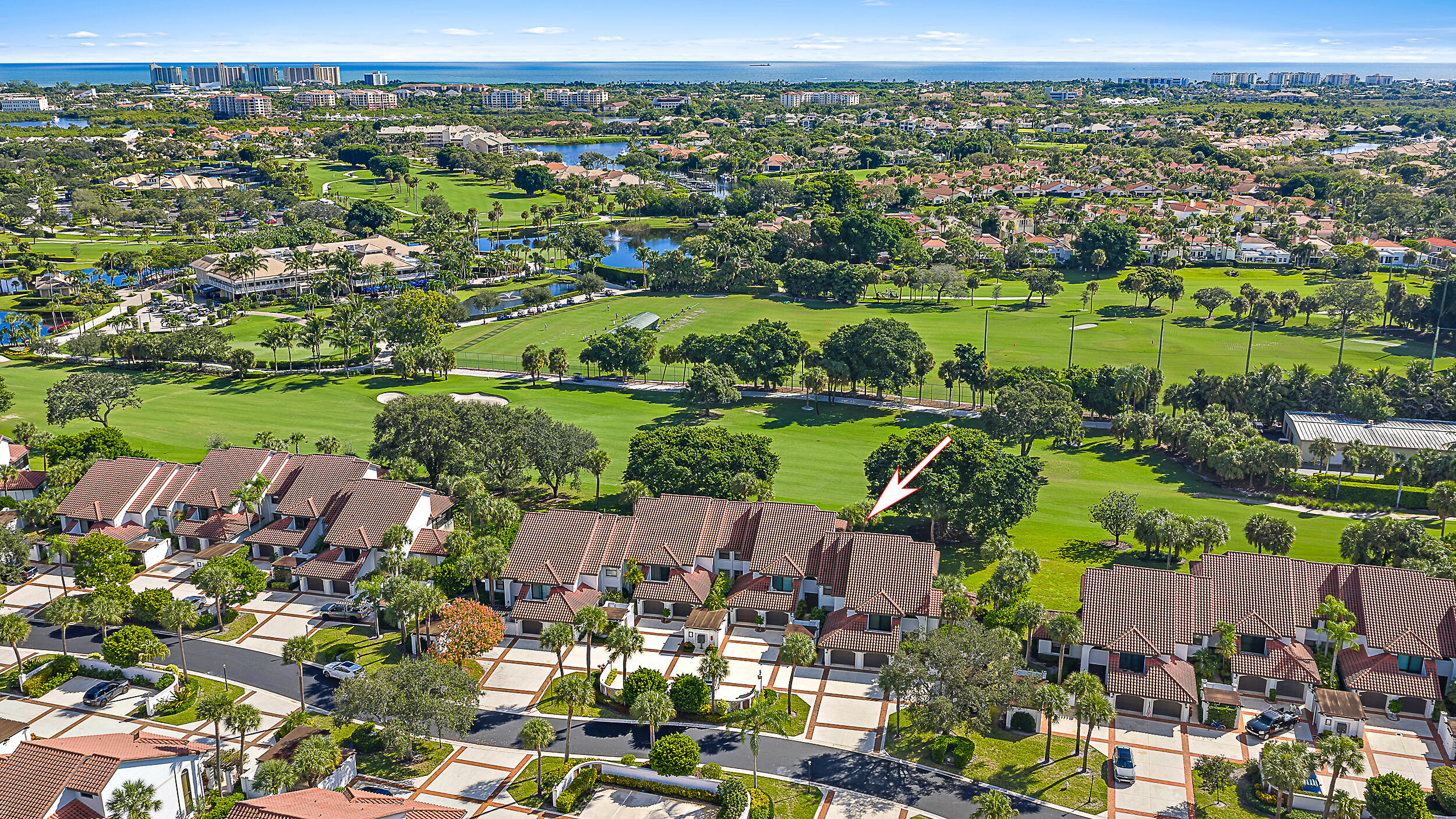 16648 Traders Crossing North, Unit 106 Jupiter, FL 33477 - Photo 29 of 37 an aerial view of a city with lots of residential buildings and mountain view in back