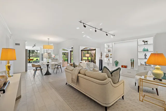 a living room with furniture a rug and a chandelier