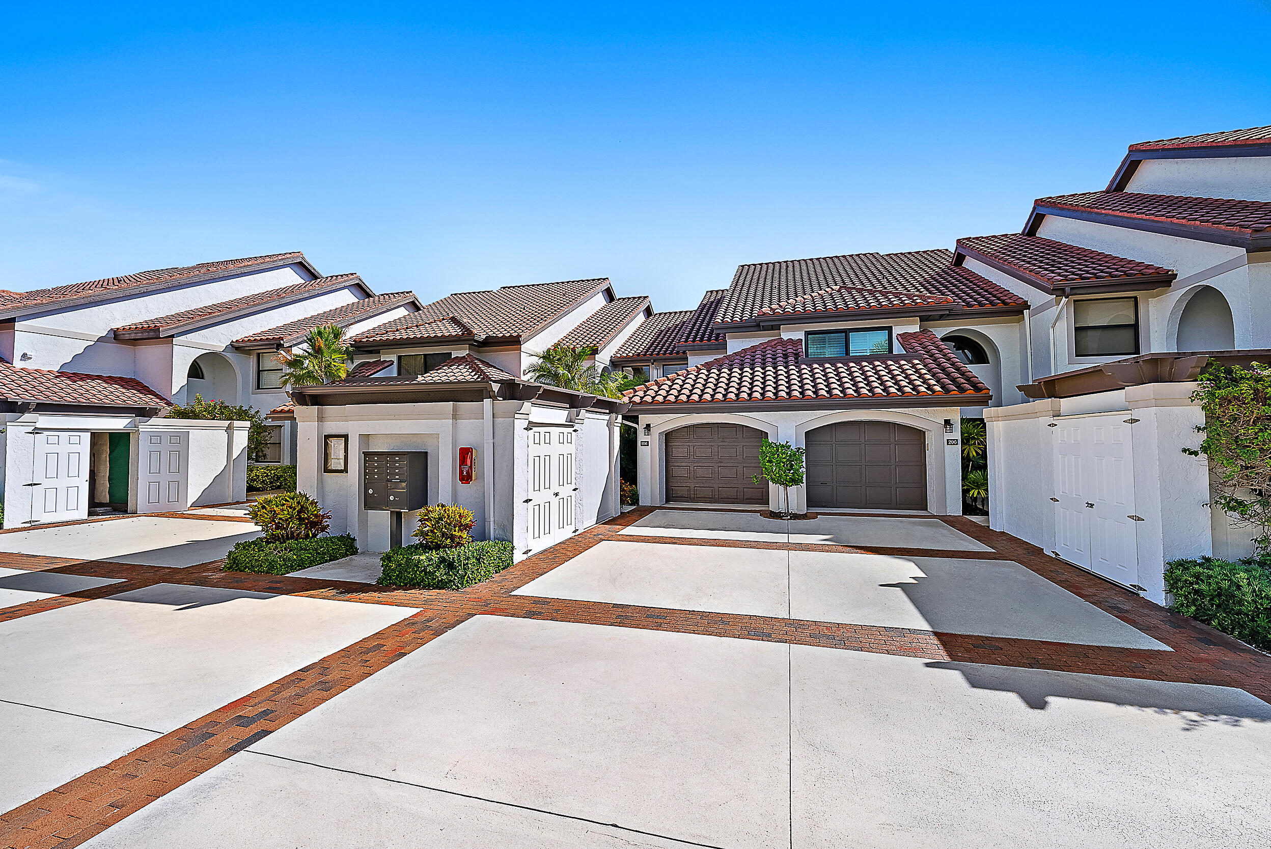 16648 Traders Crossing North, Unit 106 Jupiter, FL 33477 - Photo 5 of 37 a front view of a house with a yard