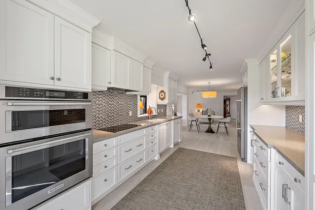 a kitchen with sink cabinets and stove top oven