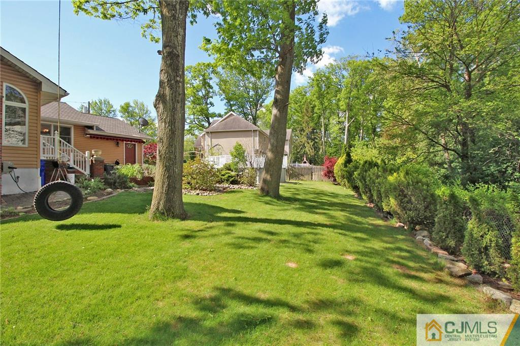 21 Frances Road Edison, NJ 08820 - Photo 2 of 20 a view of a backyard with table and chairs and potted plants