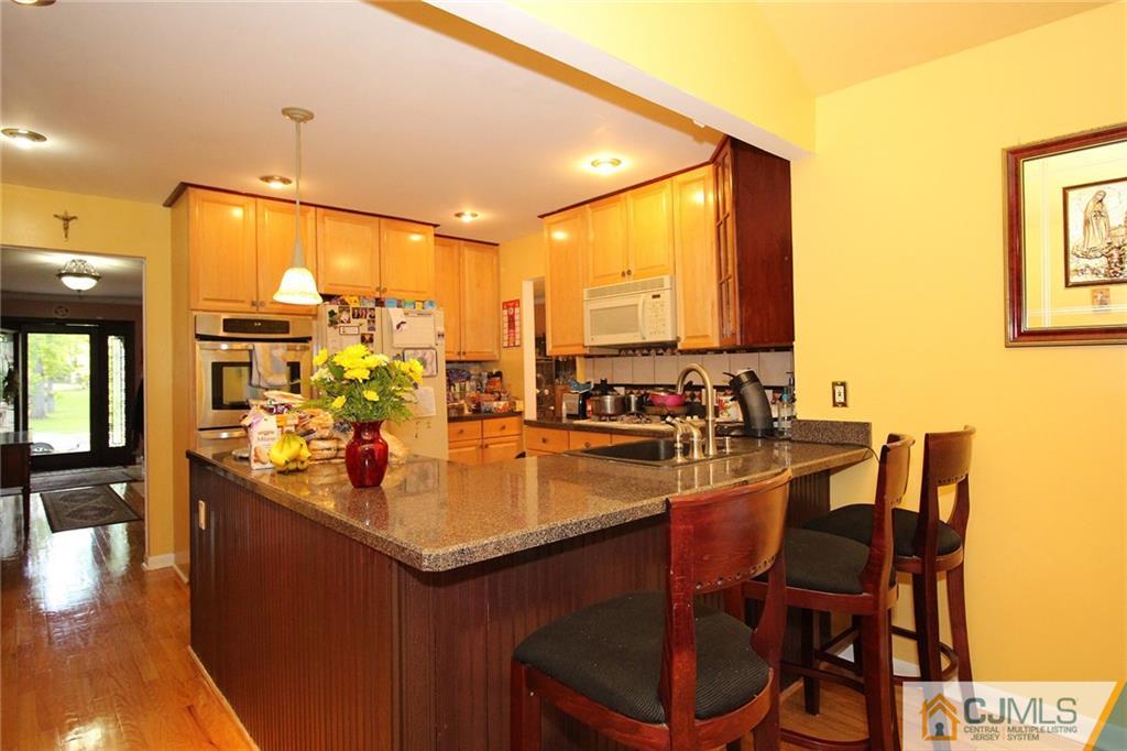 21 Frances Road Edison, NJ 08820 - Photo 15 of 20 a kitchen with a table chairs sink and stove